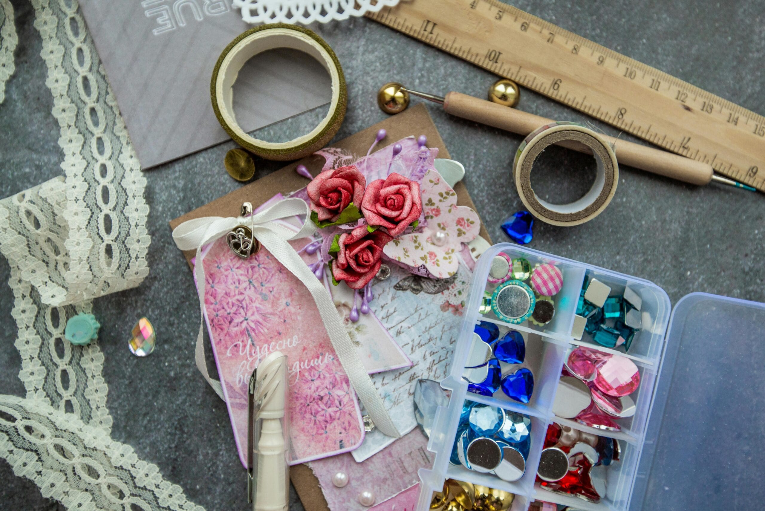 A vibrant flat lay of craft supplies including lace, beads, and handmade cards, perfect for designers.